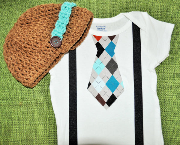 boy plaid argyle cake smash, brown teale and blue tie bodysuit and suspenders with brown and teal crochet hat.