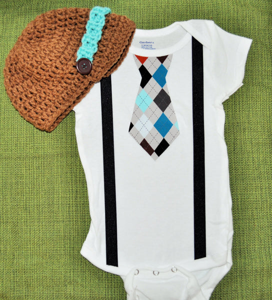 boy plaid argyle cake smash, brown teale and blue tie bodysuit and suspenders with brown and teal crochet hat.