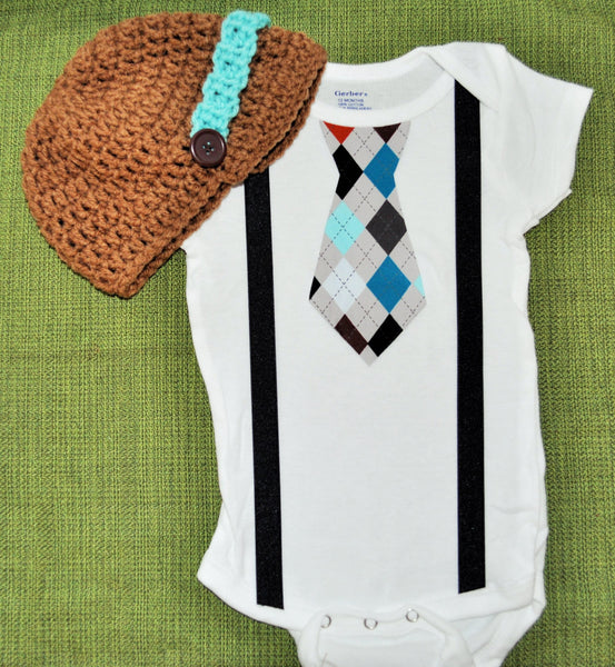 boy plaid argyle cake smash, brown teale and blue tie bodysuit and suspenders with brown and teal crochet hat.