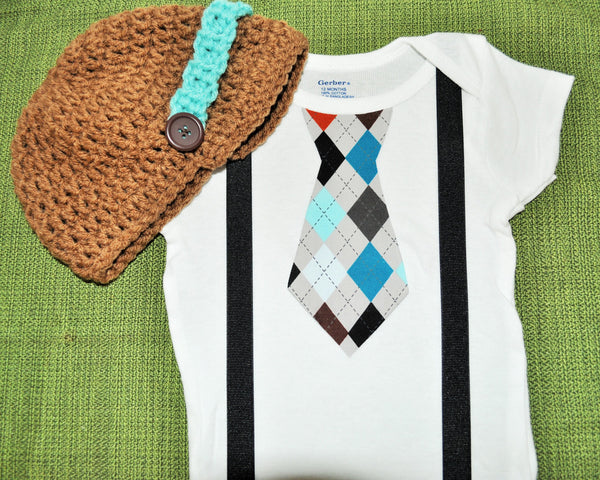 boy plaid argyle cake smash, brown teale and blue tie bodysuit and suspenders with brown and teal crochet hat.